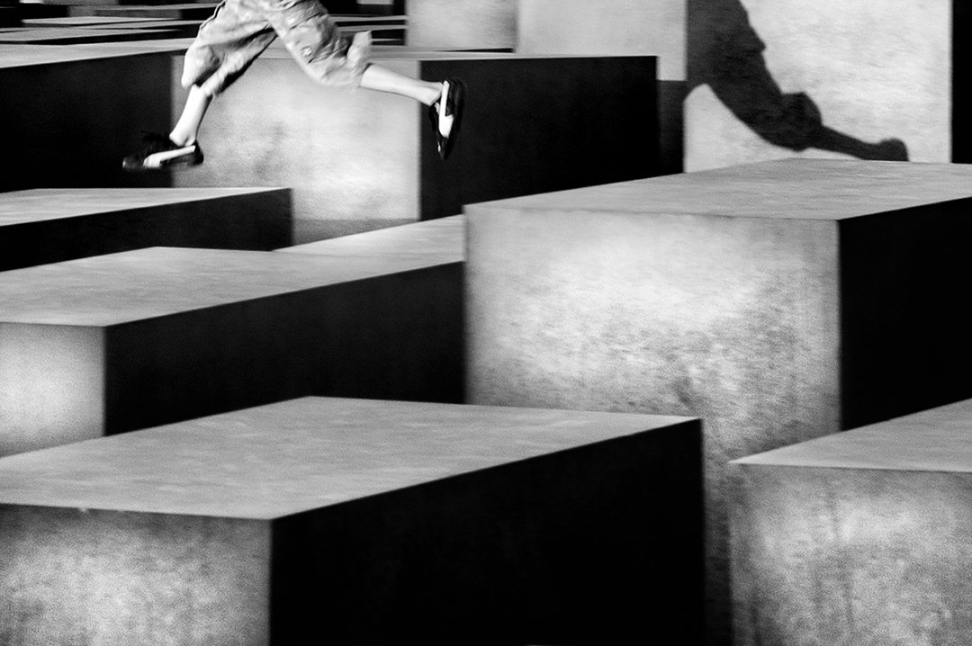Legs jumping between large rectangular blocks.